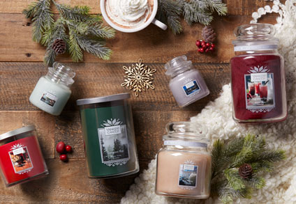Assortment of candles spread out on a wooden table